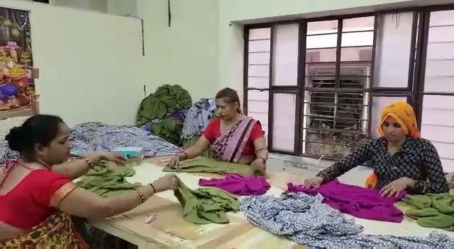 Artisans sorting finished garments
