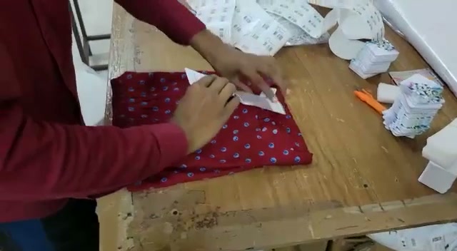 Attaching labels to a finished garment
